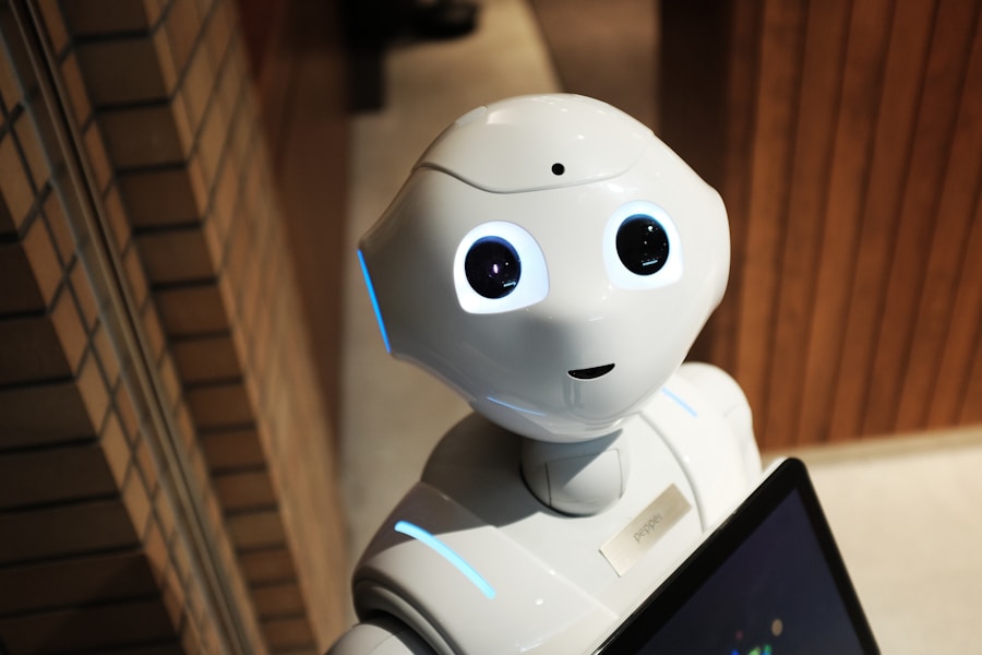 A small robot holding a tablet, looking very pleased with itself